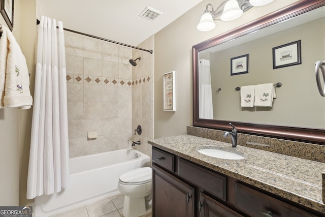 full bathroom featuring tile patterned floors, shower / bath combo with shower curtain, vanity, and toilet