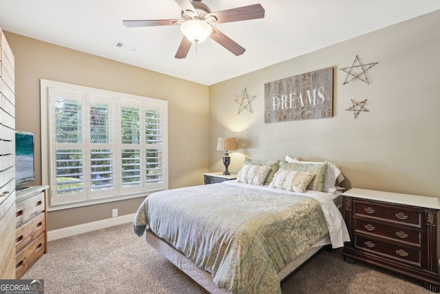 carpeted bedroom featuring ceiling fan and multiple windows