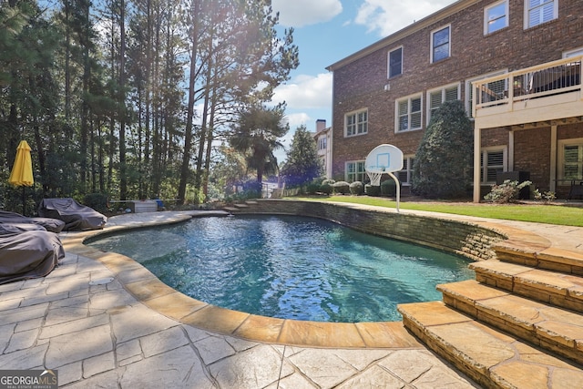 view of swimming pool with a patio