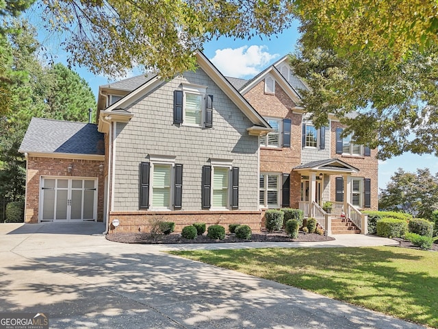 view of front of house with a front lawn and a garage