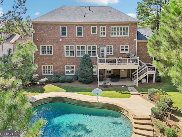 rear view of house featuring a swimming pool side deck and a patio