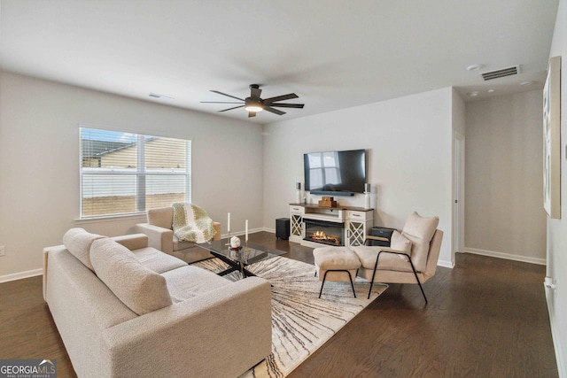 living room with dark hardwood / wood-style floors and ceiling fan