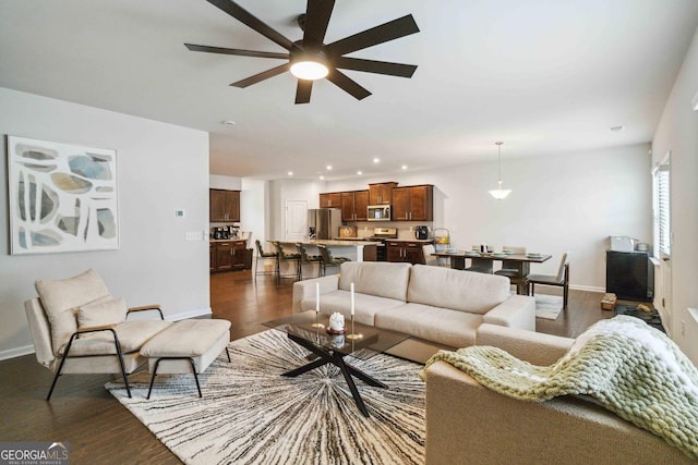 living room with dark hardwood / wood-style floors and ceiling fan