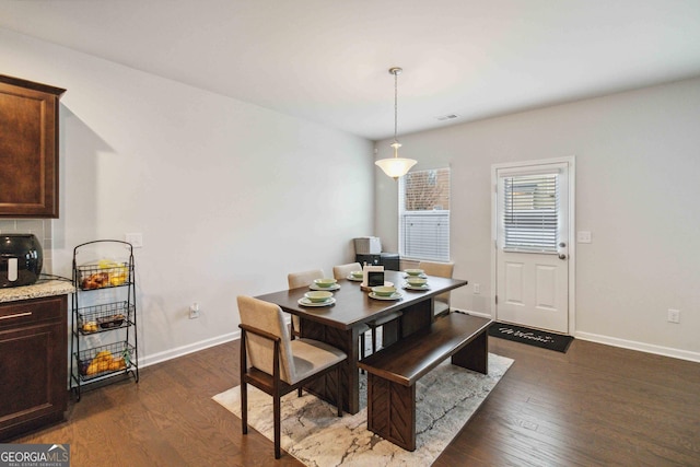 dining area featuring dark hardwood / wood-style floors