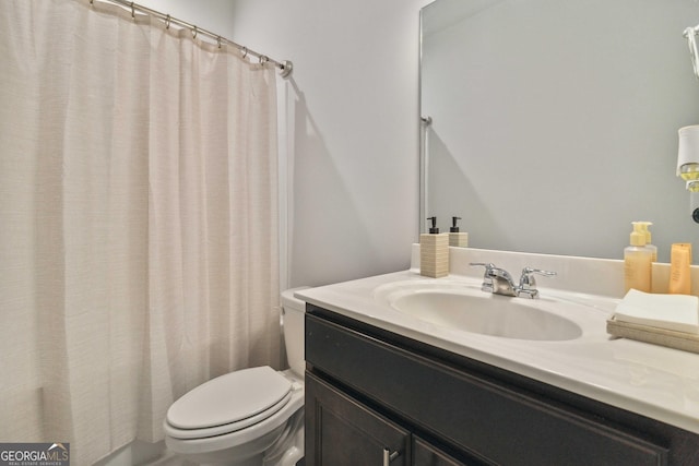 bathroom featuring vanity and toilet