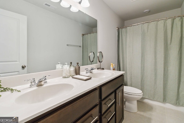 bathroom with tile patterned floors, vanity, and toilet