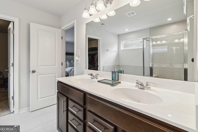 bathroom featuring vanity, tile patterned floors, and a shower with door