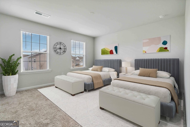 bedroom with radiator heating unit and light colored carpet