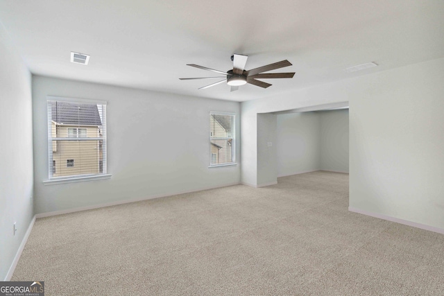 unfurnished room with ceiling fan and light colored carpet