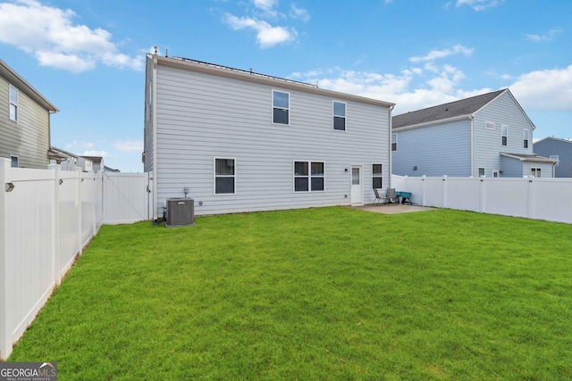 back of property featuring central AC, a patio area, and a lawn