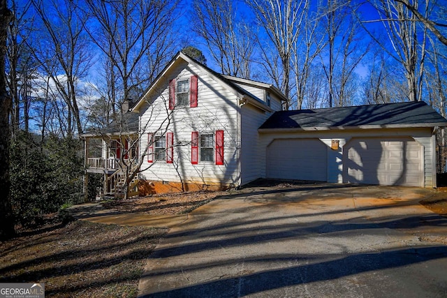 view of home's exterior featuring a garage and a porch