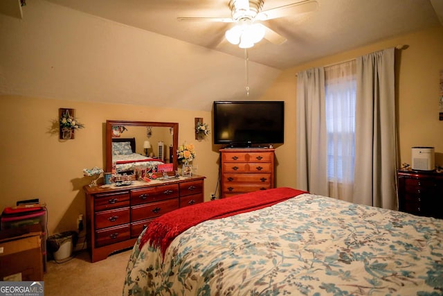 carpeted bedroom featuring ceiling fan and vaulted ceiling