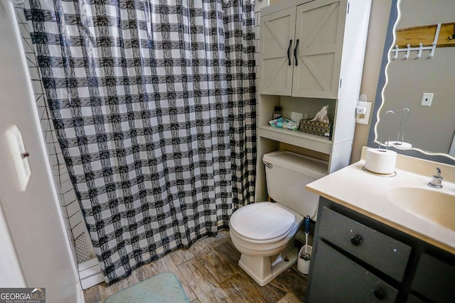 bathroom featuring a shower with shower curtain, vanity, and toilet