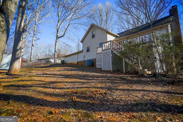 view of property exterior featuring a deck and central AC