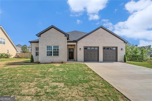 view of front of home with a garage and a front lawn