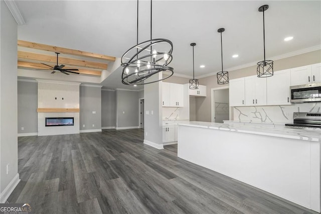 kitchen with decorative backsplash, light stone counters, stainless steel appliances, ceiling fan, and white cabinets