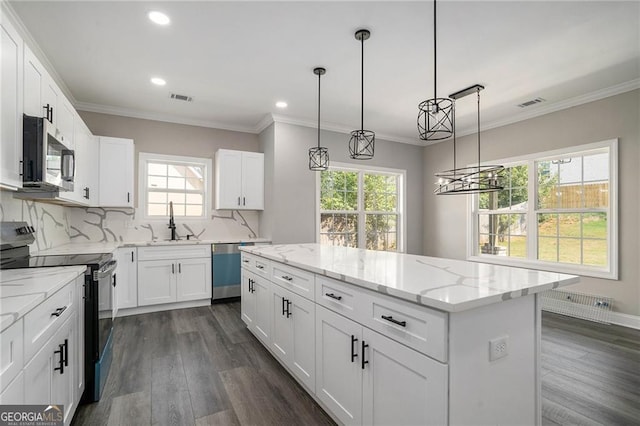 kitchen featuring white cabinetry, a center island, and stainless steel appliances