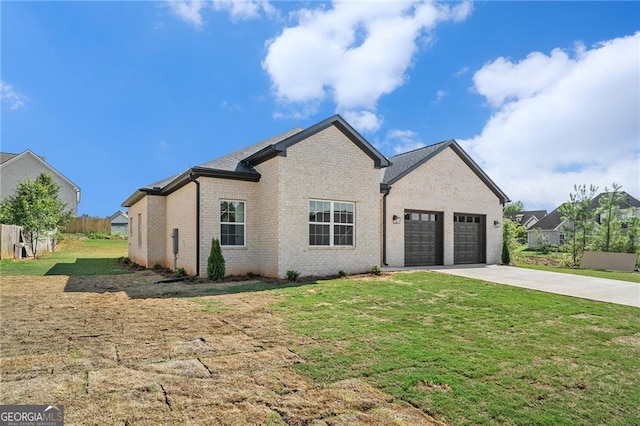 view of front of home featuring a front lawn and a garage