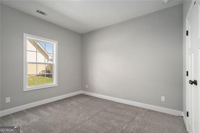 unfurnished room featuring light carpet