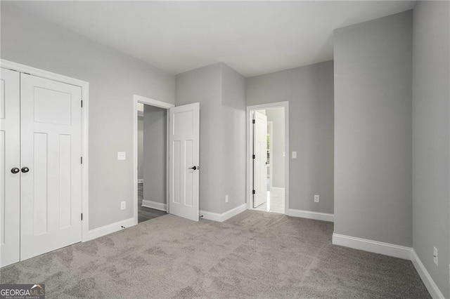 unfurnished bedroom with a closet and carpet