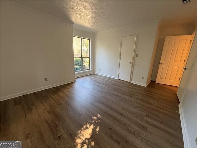 unfurnished bedroom featuring dark hardwood / wood-style floors, ornamental molding, and a textured ceiling