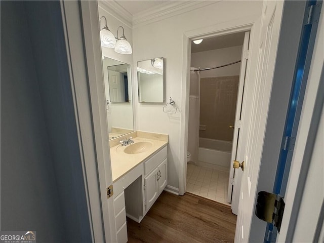 full bathroom with ornamental molding, vanity, shower / bath combo with shower curtain, hardwood / wood-style floors, and toilet