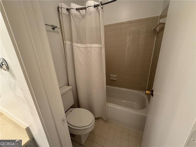 bathroom featuring tile patterned flooring, shower / bath combination with curtain, and toilet