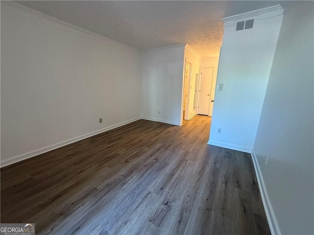 spare room featuring crown molding and hardwood / wood-style floors