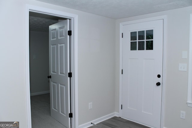 foyer entrance with a textured ceiling