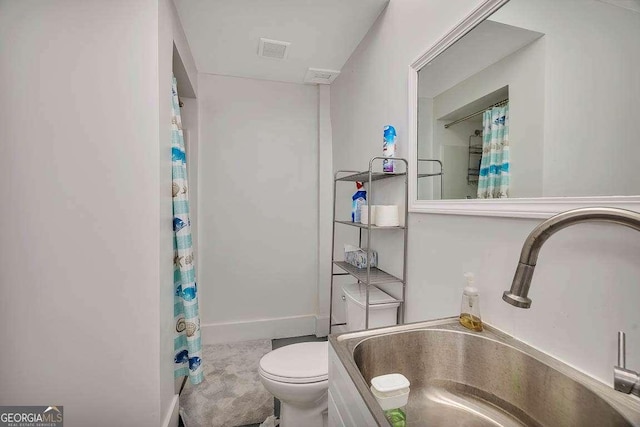 bathroom featuring toilet and sink