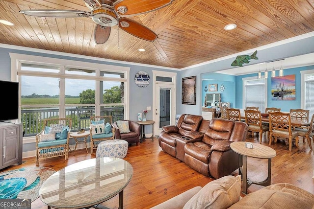 living room featuring ceiling fan, light hardwood / wood-style floors, ornamental molding, and wood ceiling