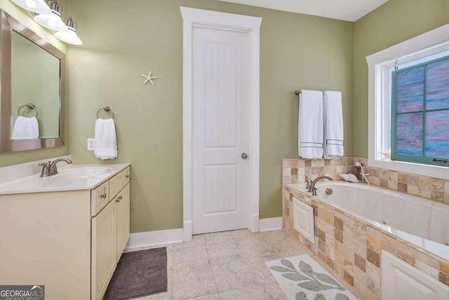 bathroom featuring tile patterned floors, vanity, and tiled bath