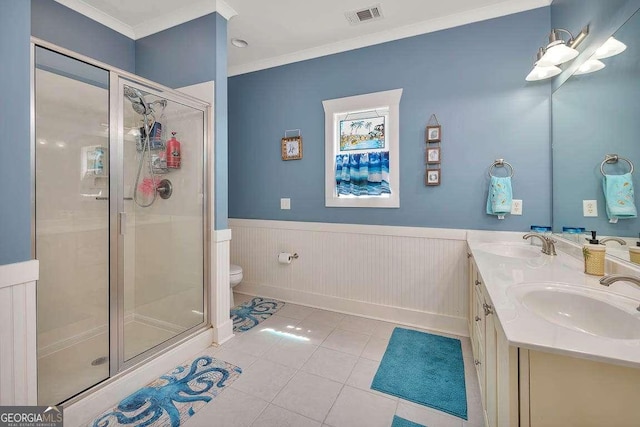 bathroom with tile patterned flooring, toilet, vanity, a shower with shower door, and ornamental molding