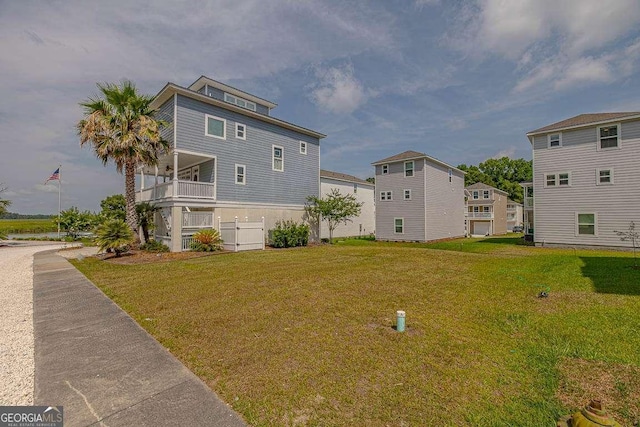 exterior space with a yard and a balcony