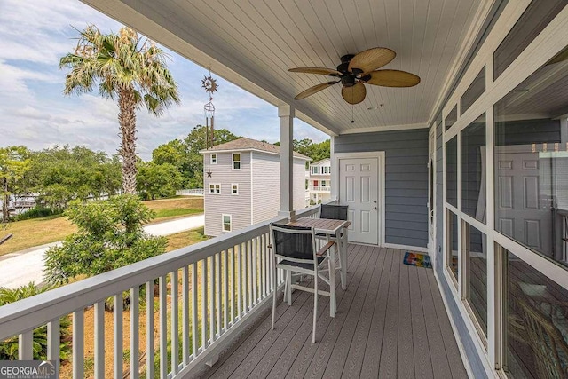 wooden deck featuring covered porch and ceiling fan