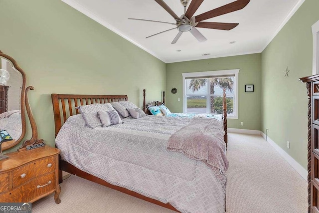 carpeted bedroom with ceiling fan and crown molding