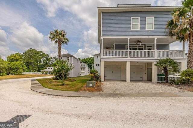 view of front of house with a garage and ceiling fan