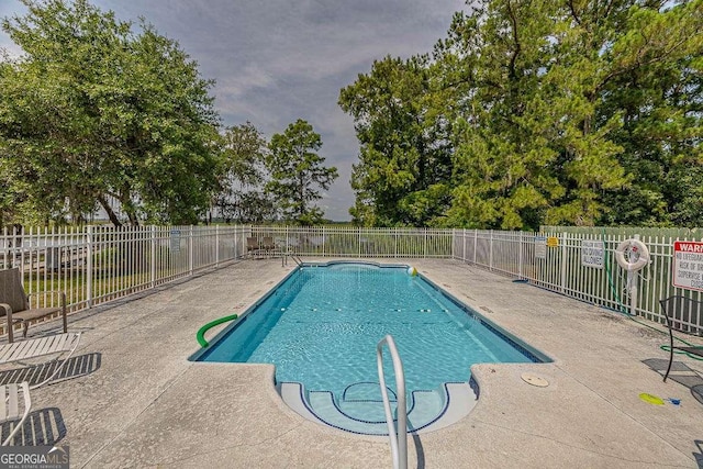 view of swimming pool featuring a patio area