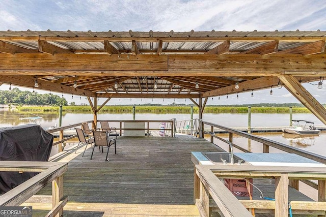 view of dock with a gazebo and a water view