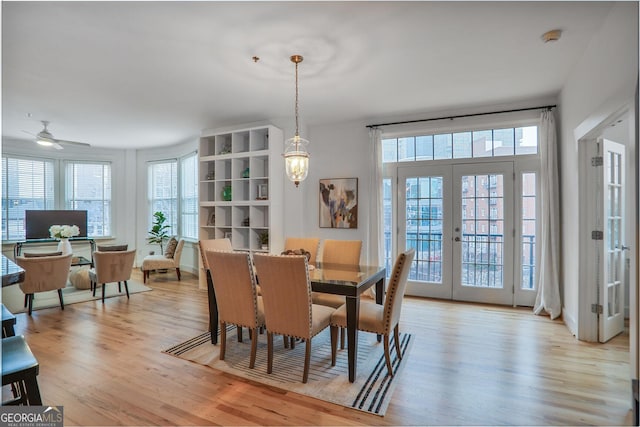 dining room with light hardwood / wood-style flooring and french doors