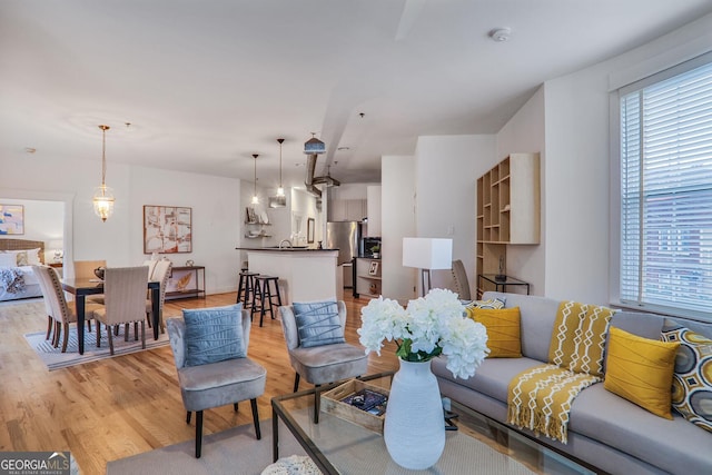 living room featuring a wealth of natural light and light hardwood / wood-style flooring