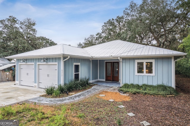 single story home with a garage and french doors