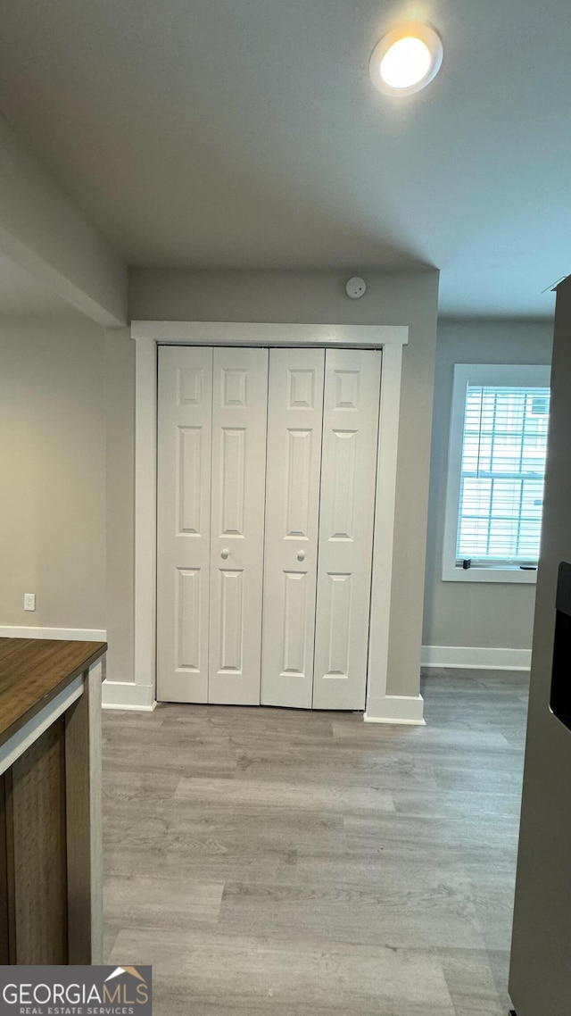 unfurnished bedroom with light hardwood / wood-style floors and a closet