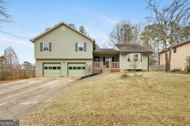 tri-level home with a porch and a garage