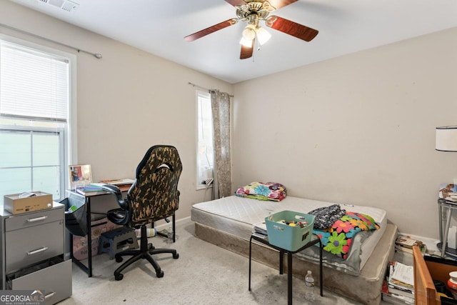 bedroom with ceiling fan and light carpet