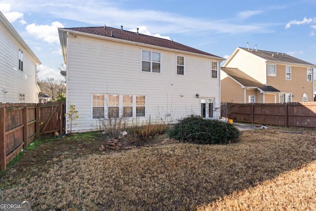 rear view of property with a lawn