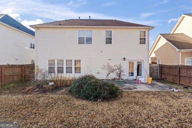 back of house with a patio and a lawn