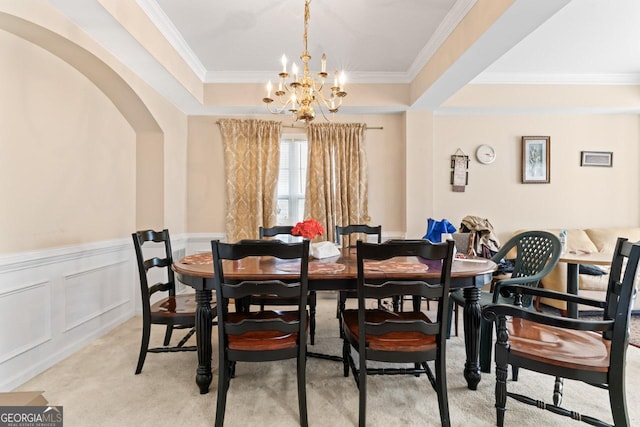 dining area with crown molding, light carpet, and a chandelier