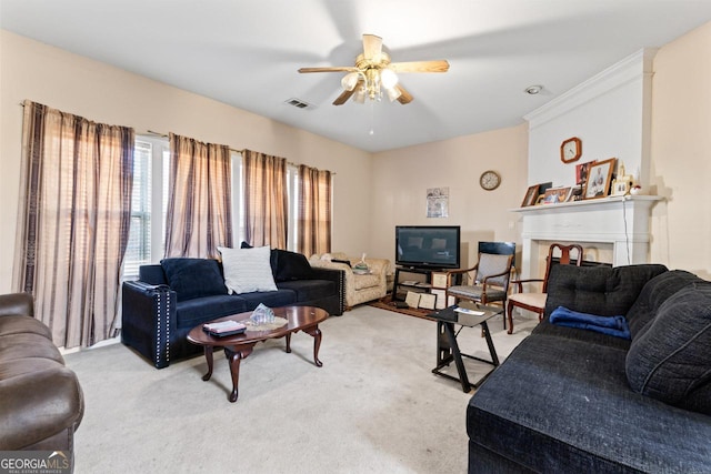 carpeted living room featuring ceiling fan