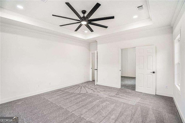 unfurnished bedroom with carpet flooring, a raised ceiling, ceiling fan, and crown molding